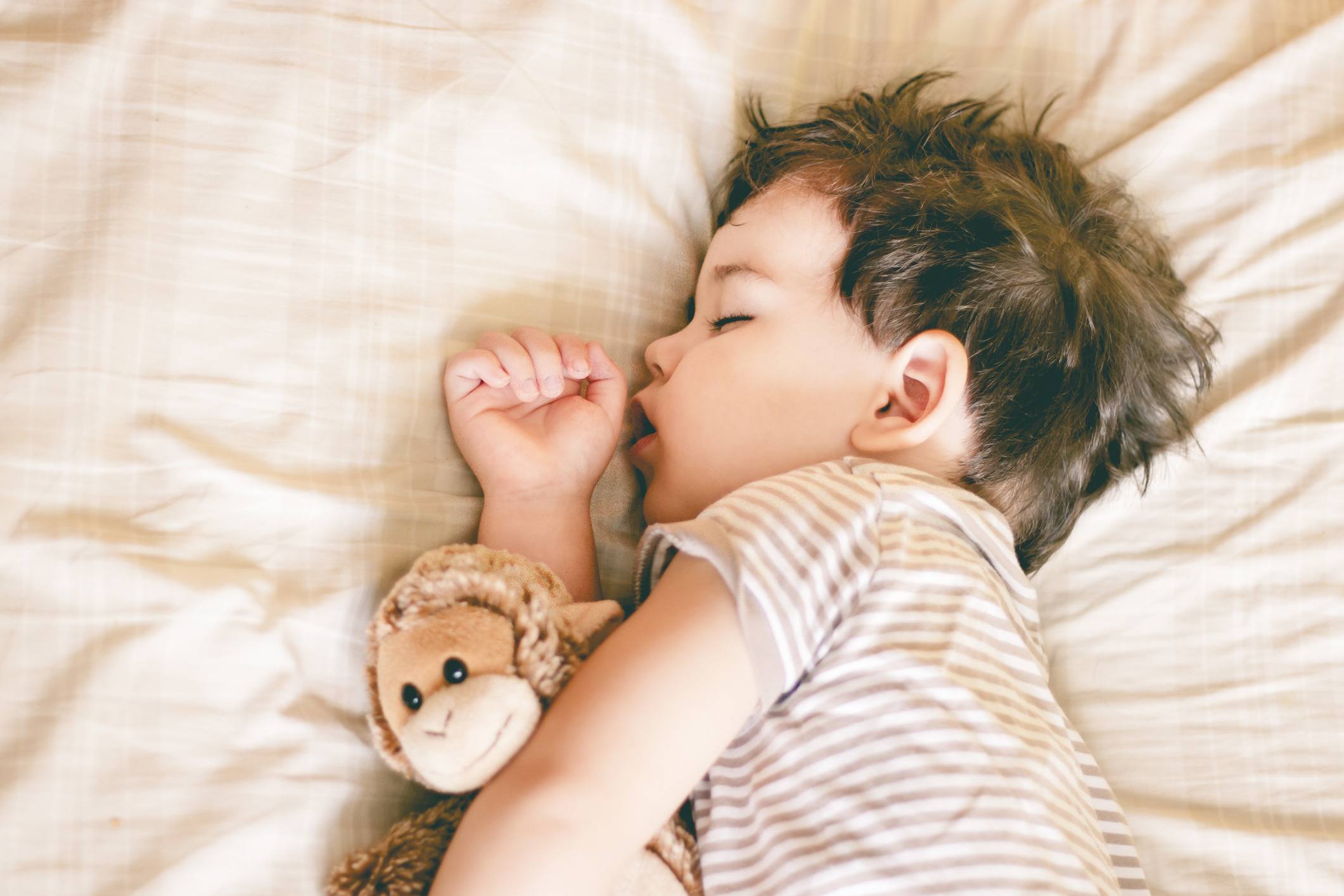 toddler sleeping in bed