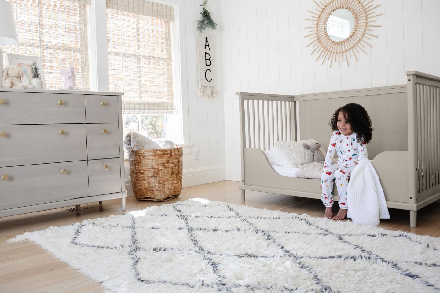 Child sitting on a converted crib