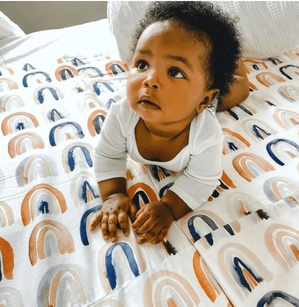 child laying on play mat