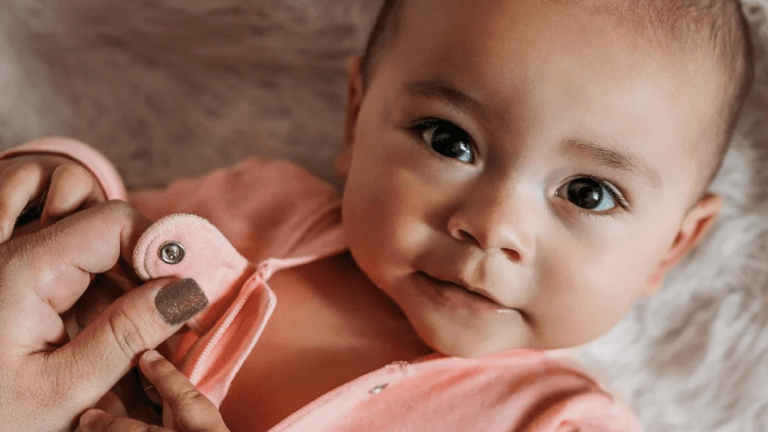 baby looking at the camera in organic baby clothes