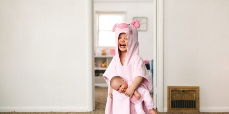 toddler crying and holding fake baby- how to help an angry child calm down