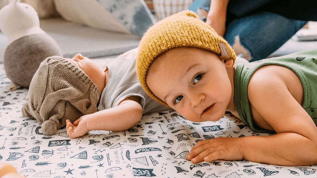 two kids playing on play mats