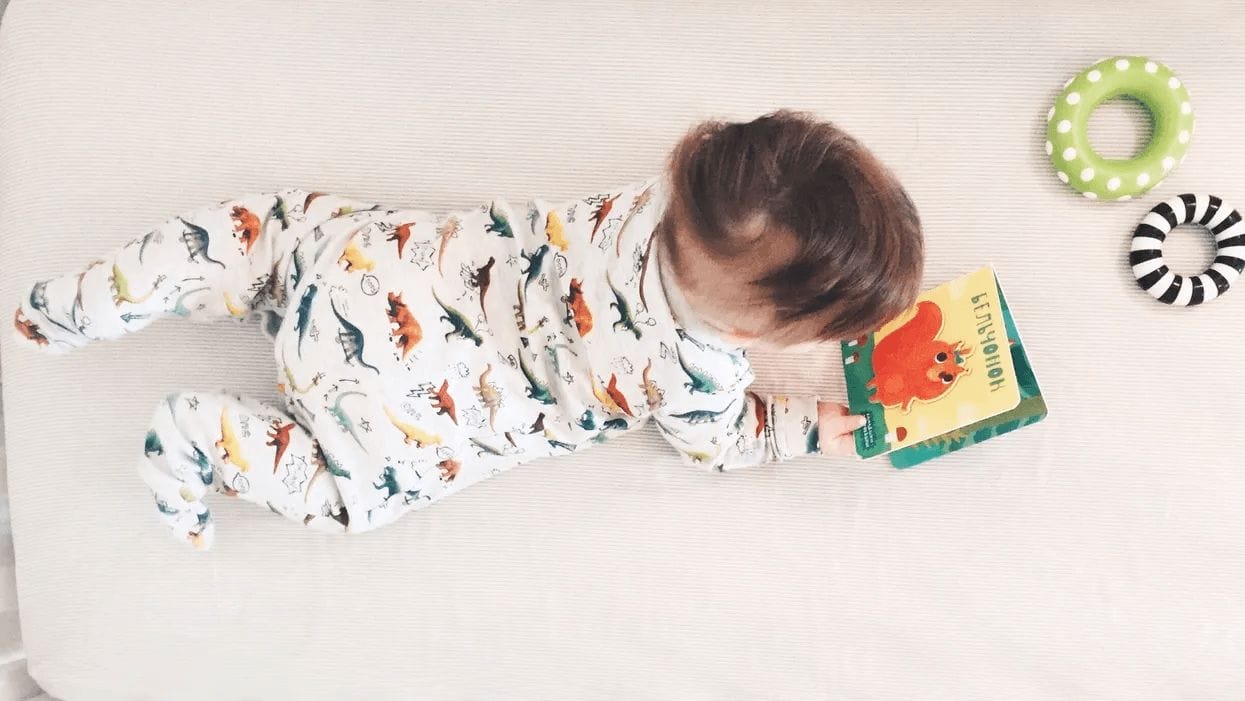 baby laying on belly looking at one of the best board books for babies