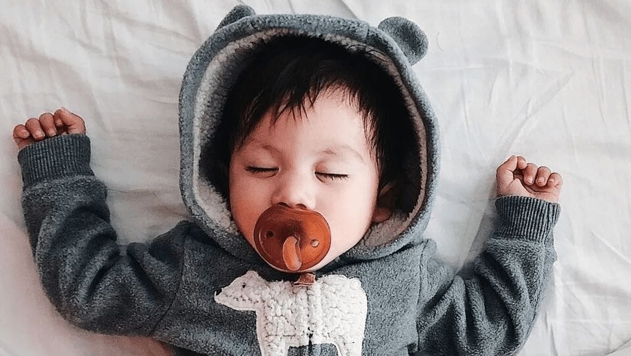 todder-sleeping-in-a-bear-outfit-with-a-pacifier