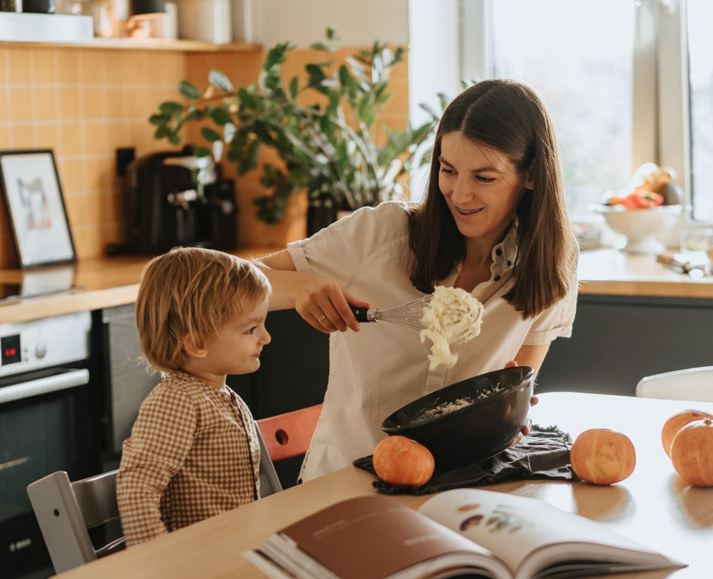 mom and kid making halloween food- halloween dinner ideas for kids