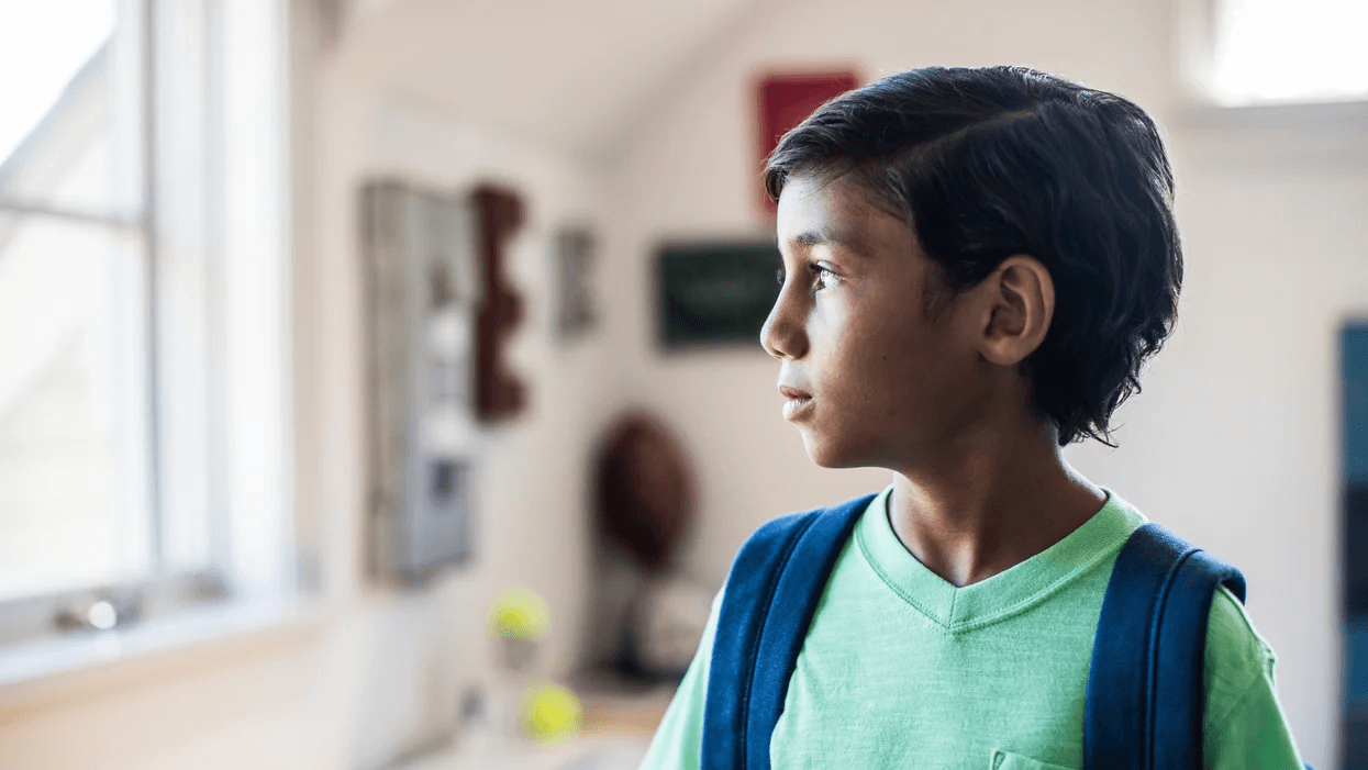 kid-looking-out-window-at-school