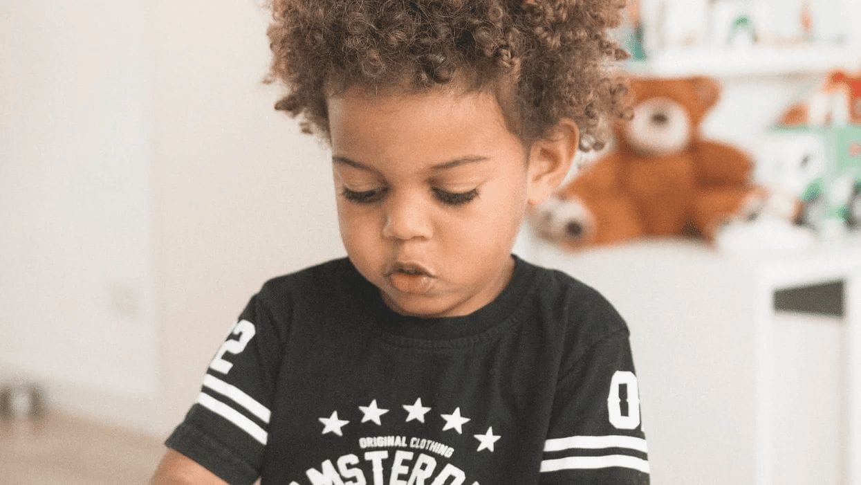 little boy playing with toys working on montessori at home techiniques