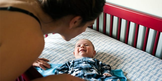 mom putting baby down for a nap