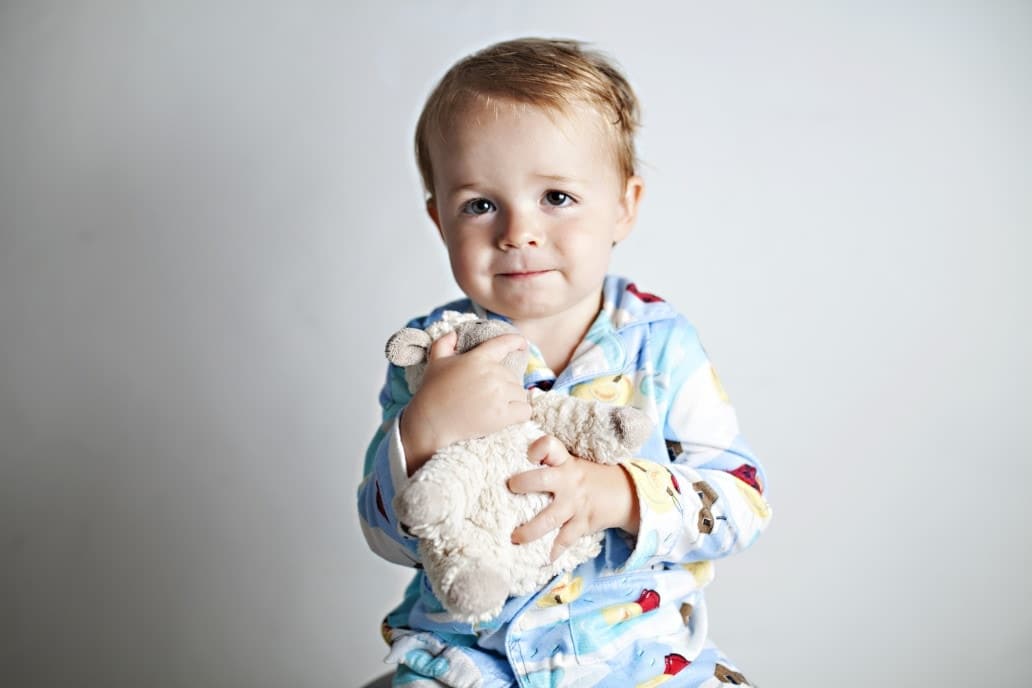 toddler holding a stuffed animal