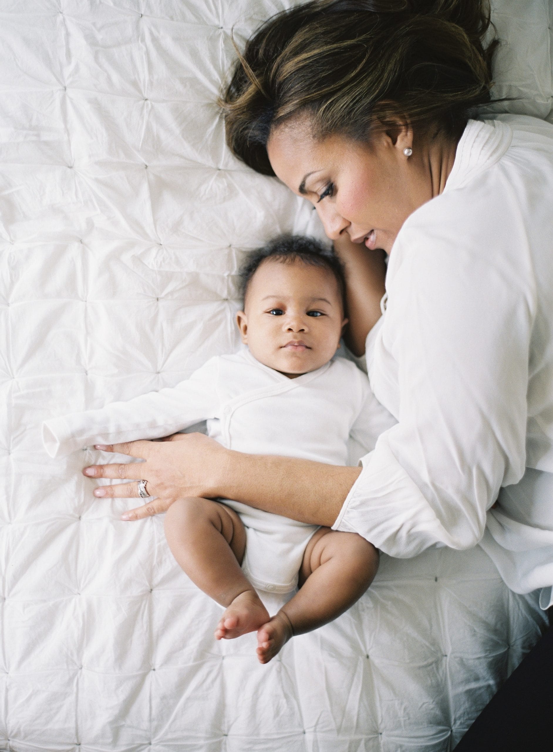 woman and baby on a bed