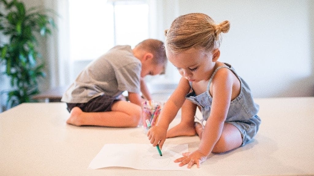 children coloring on the floor