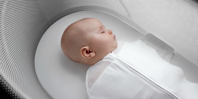 baby sleeping in a bassinet