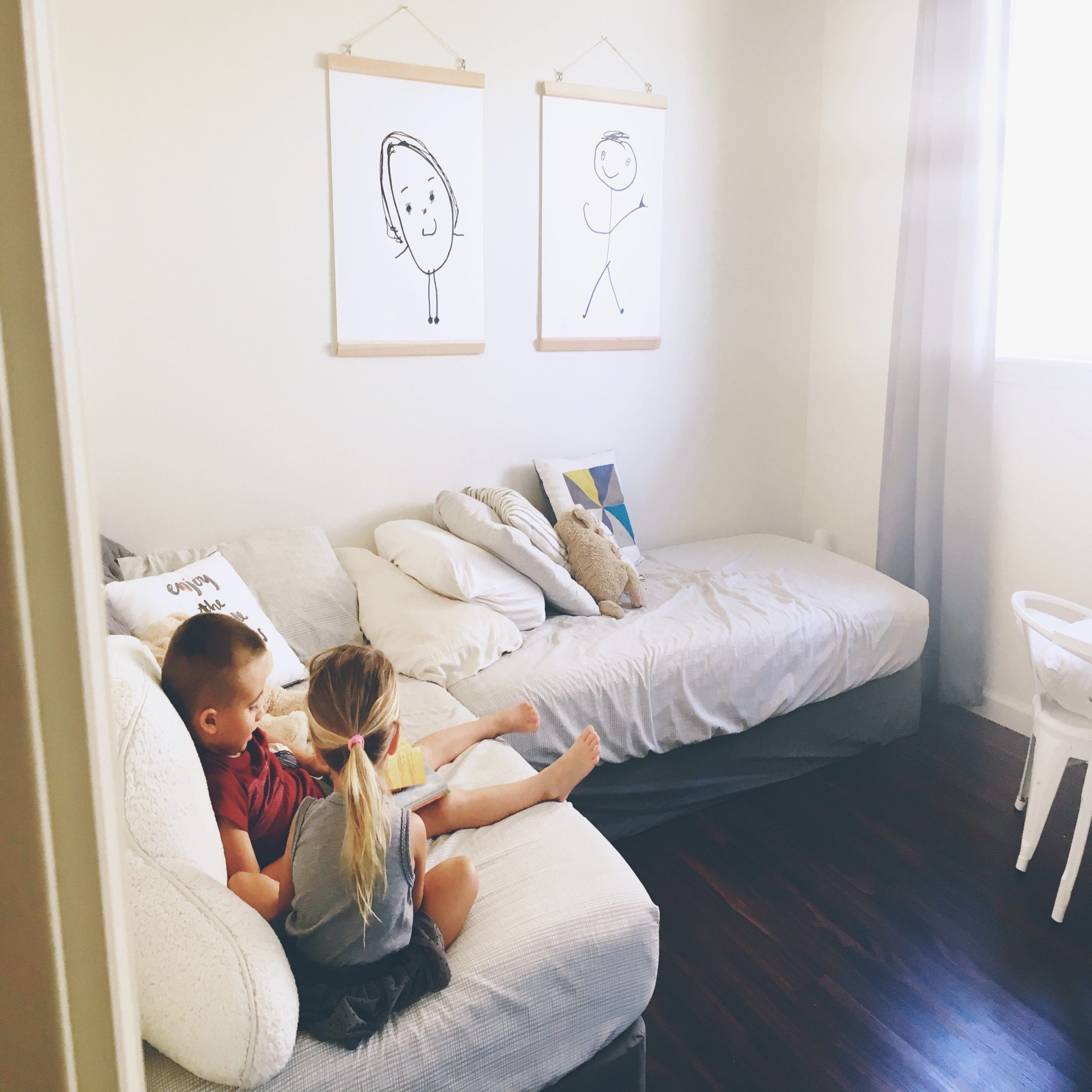 two kids playing together on a couch