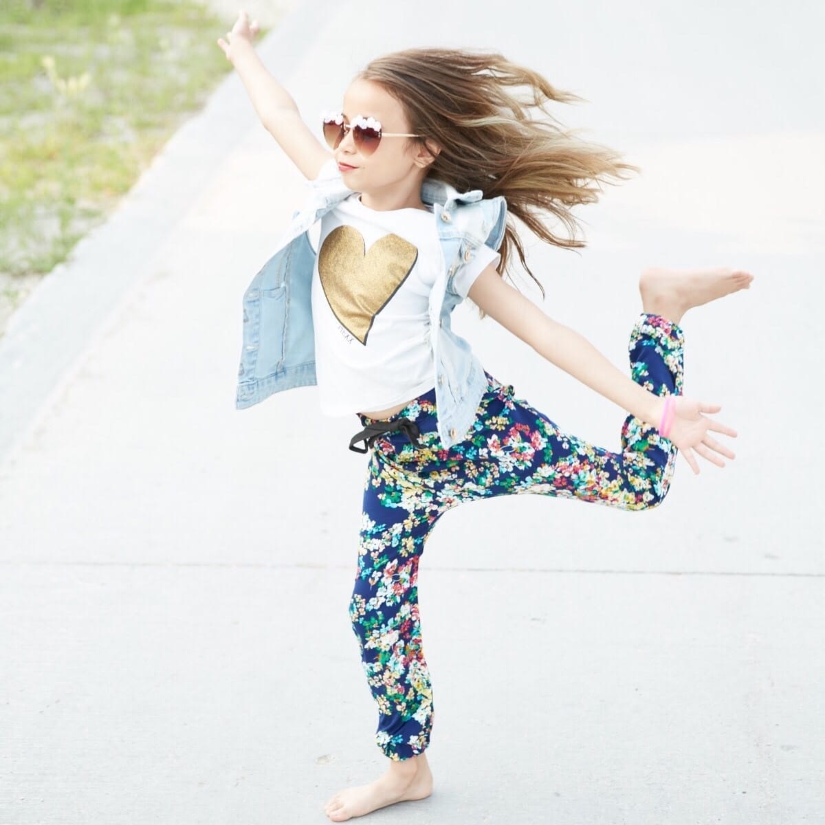 child dancing on the sidewalk