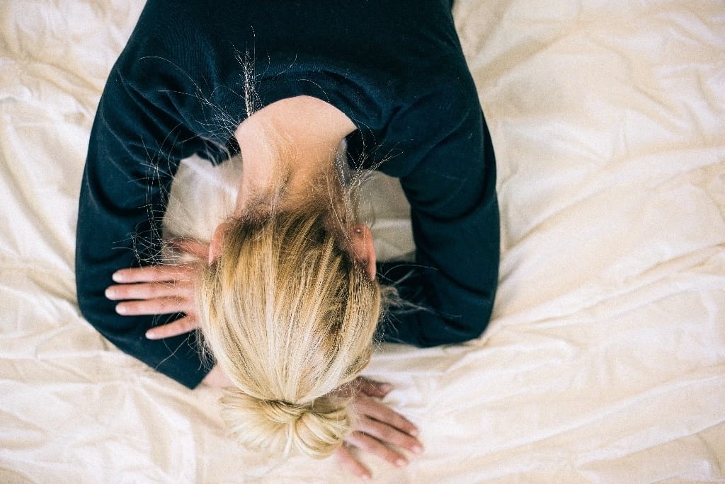 woman with her head in her hands