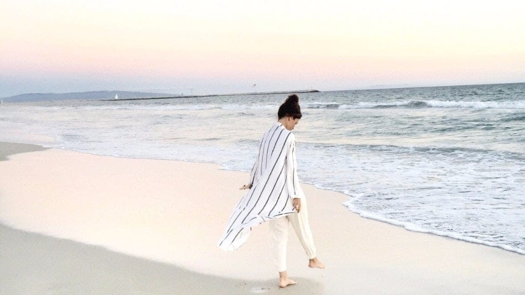 mom walking alongside a beach