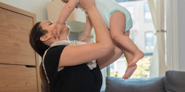 Woman holding toddler up