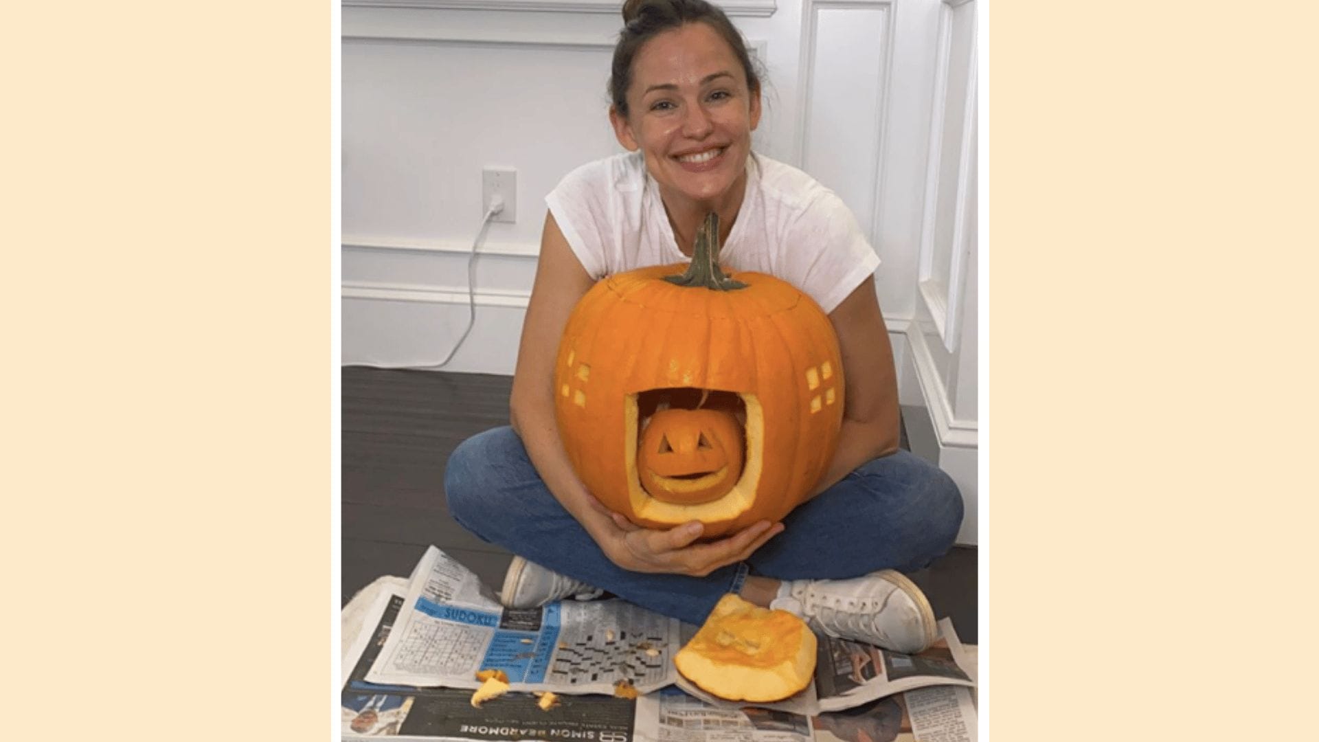 Jennifer Garner with a big pumpkin in front of her