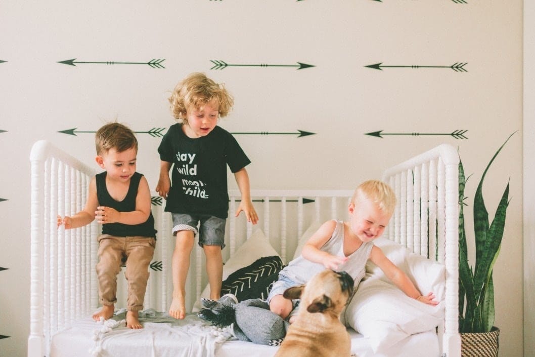 kids playing on a toddler bed