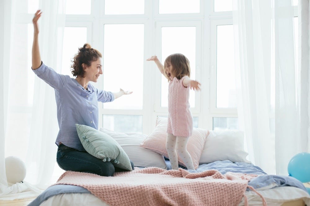 mom playing with little girl