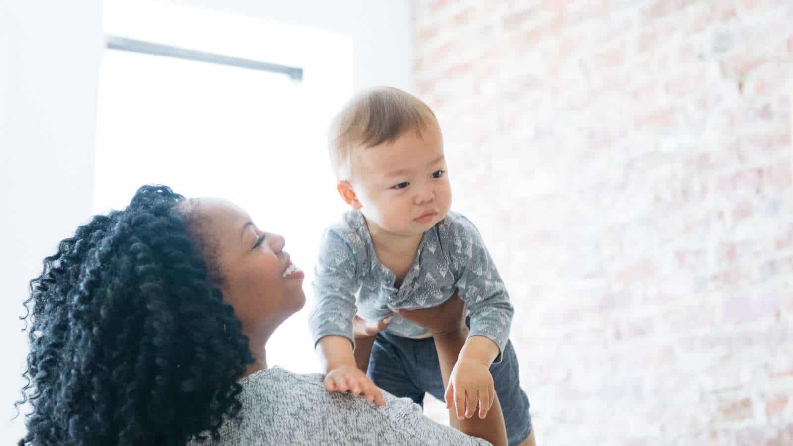 woman lifting up a baby