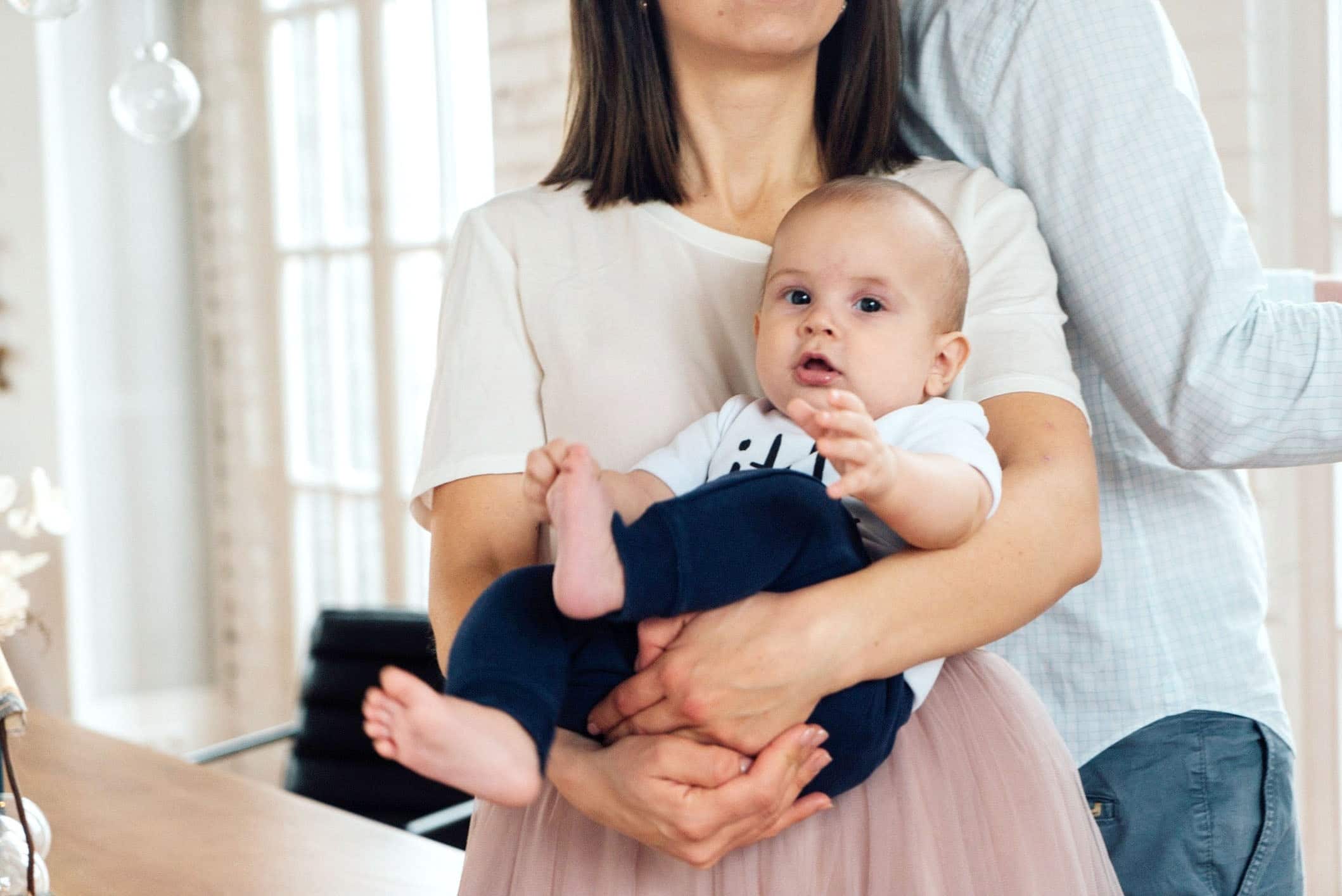 mom holding a baby in her arms - difficult babies