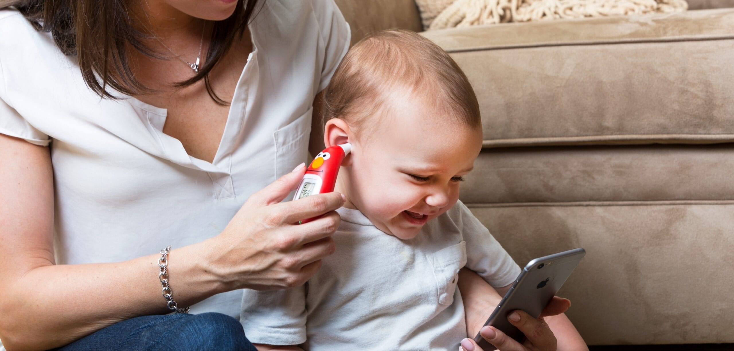 mom taking a baby's temperature