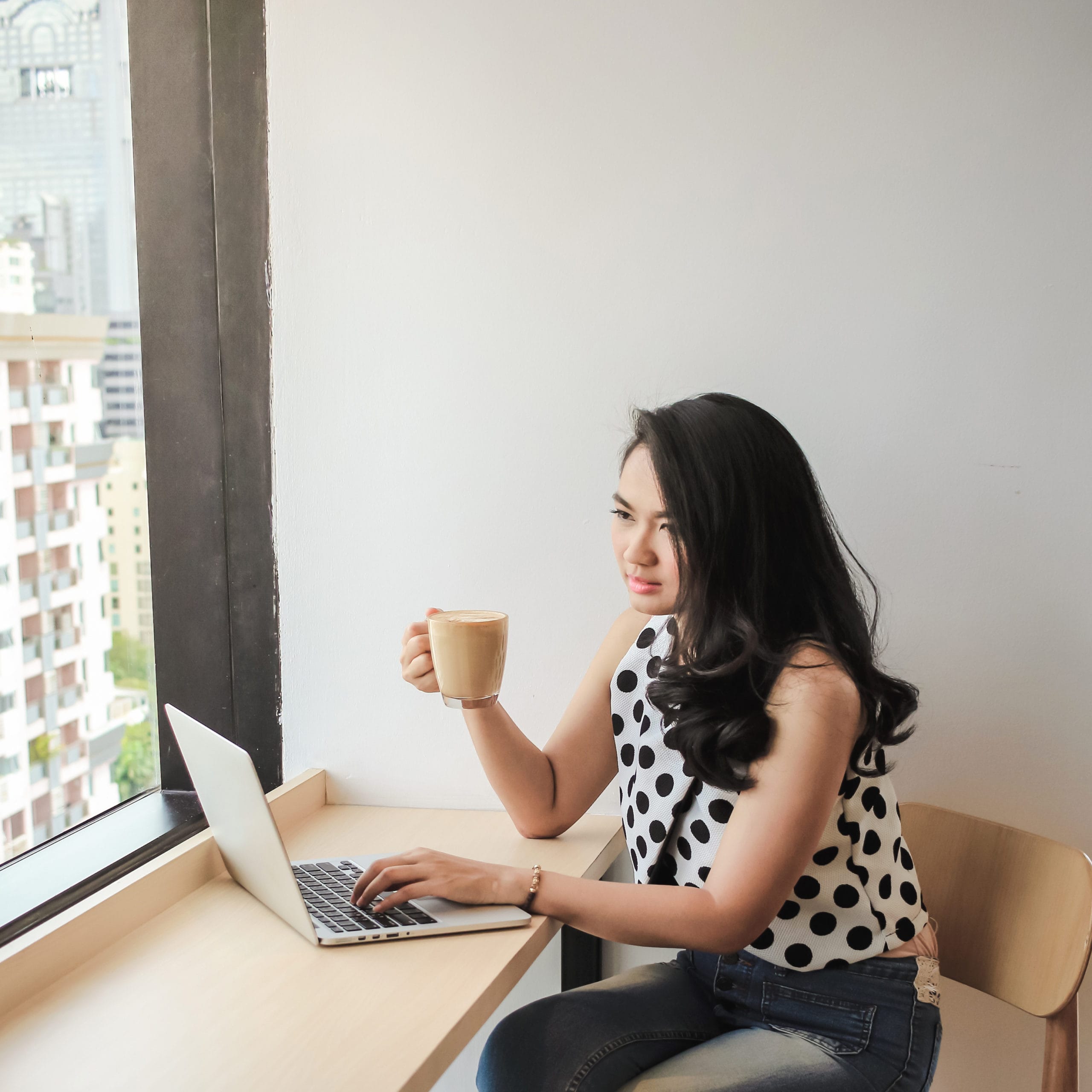 woman sitting at desk working on laptop