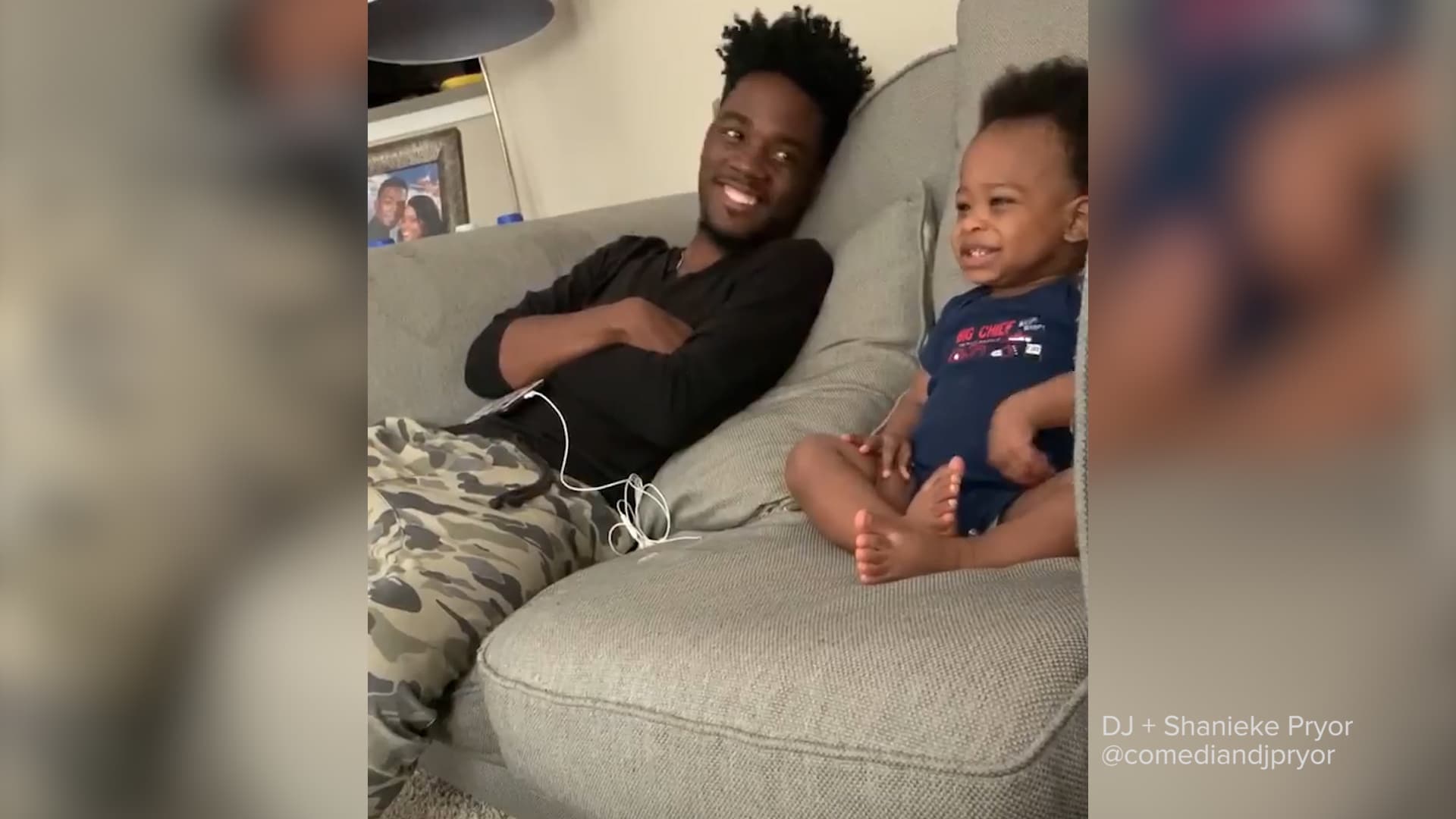 baby and dad sitting on a couch