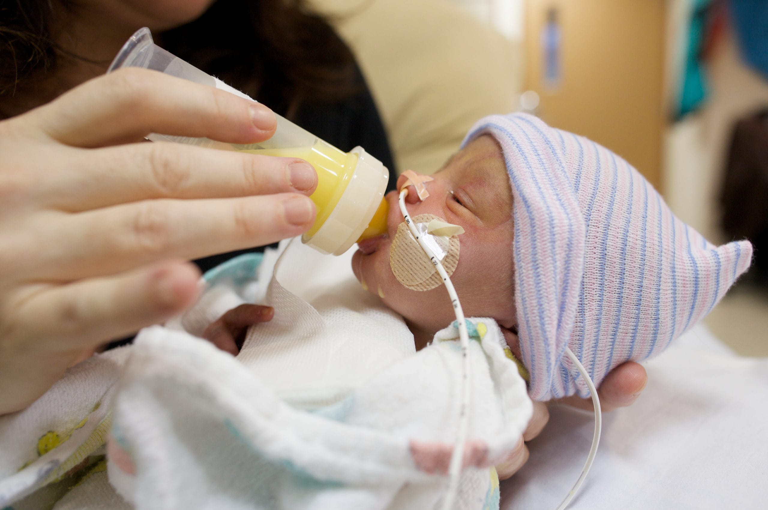 preemie baby being fed- exclusively pumping my preemie