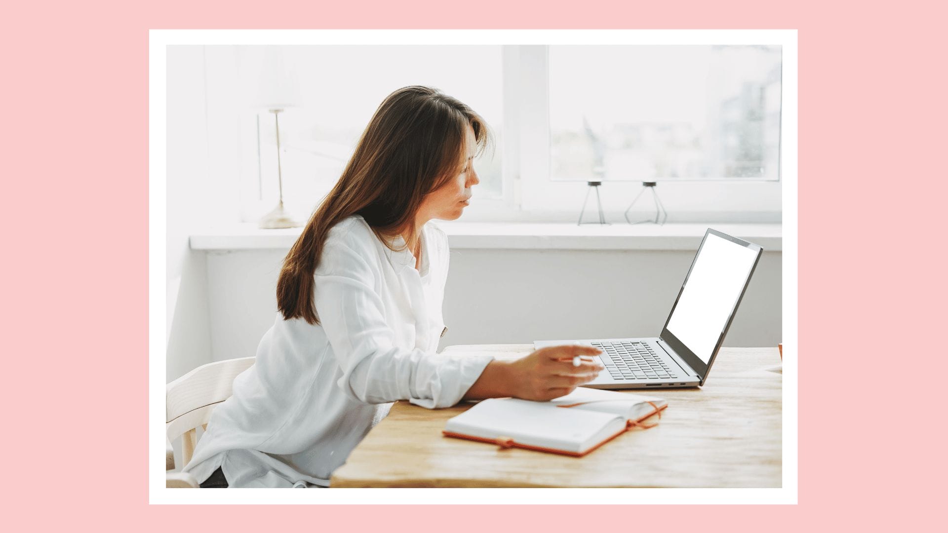 woman sitting at desk working on laptop