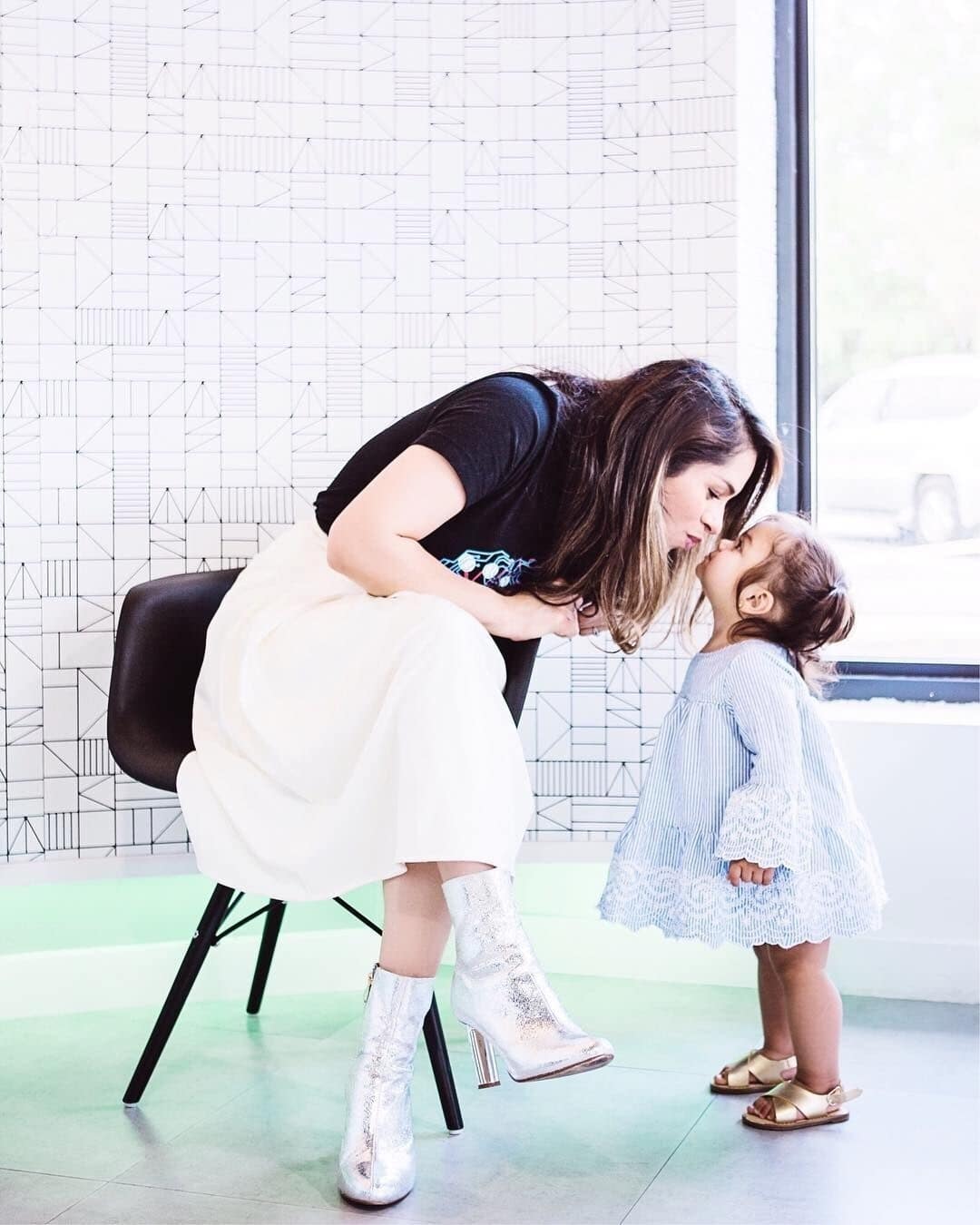 mom kissing daughter