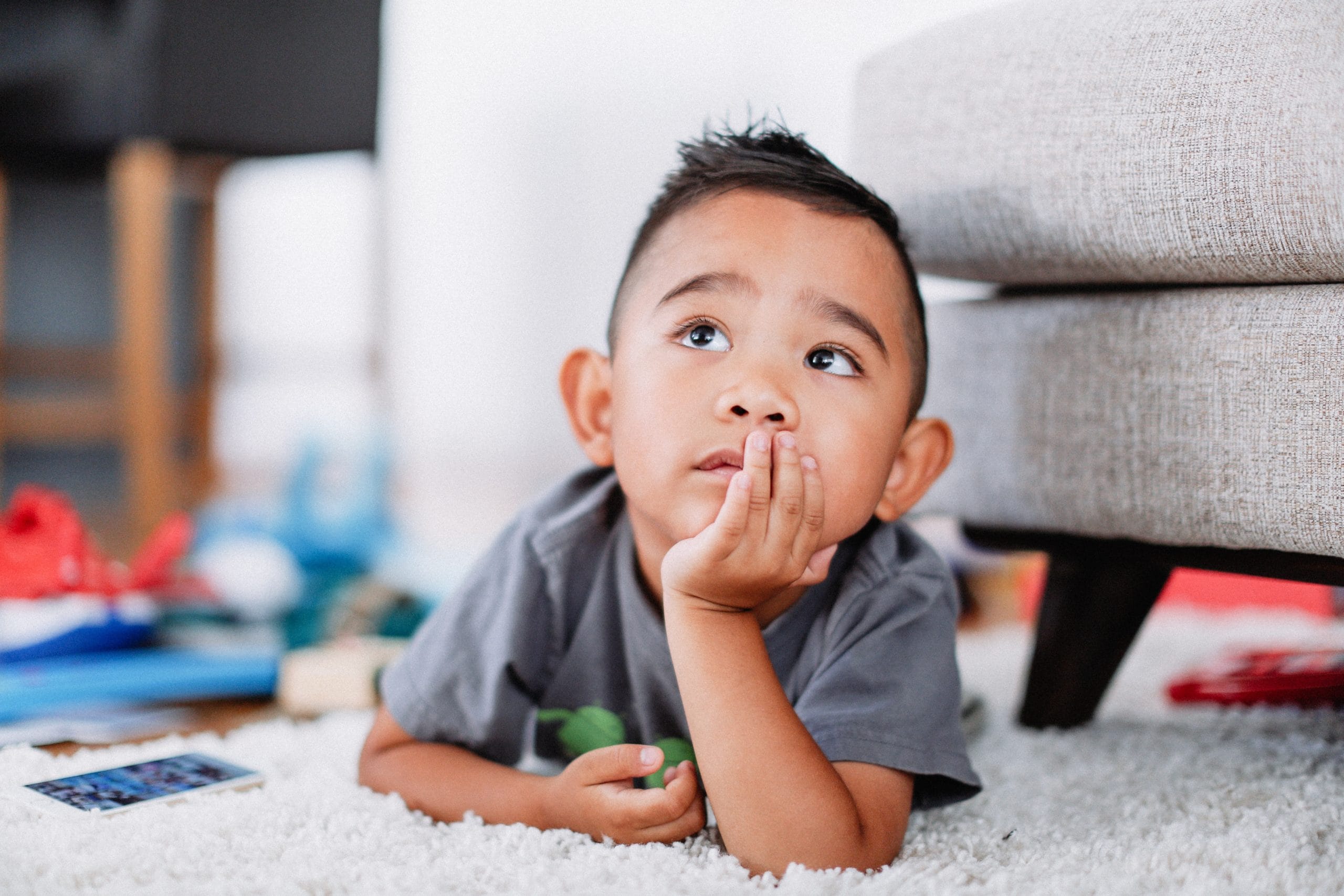 little boy resting on his hand