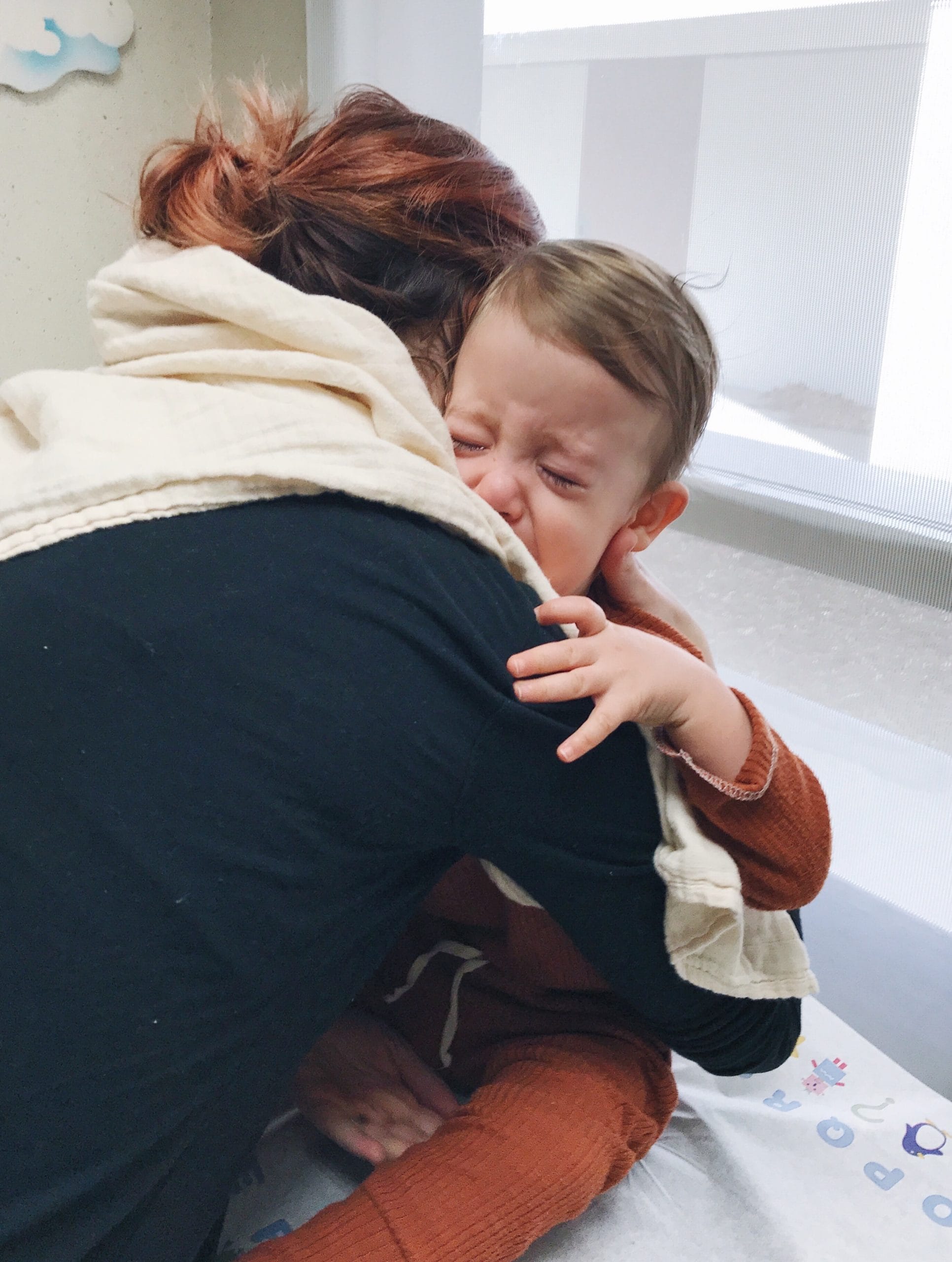 toddler crying and hugging mom