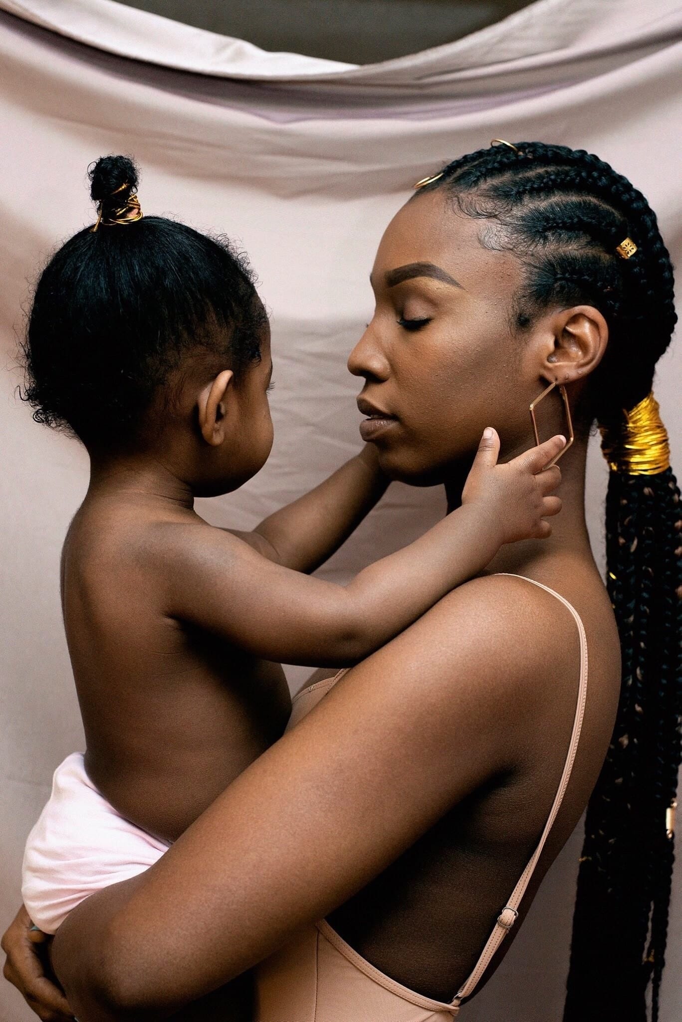 child embracing moms face