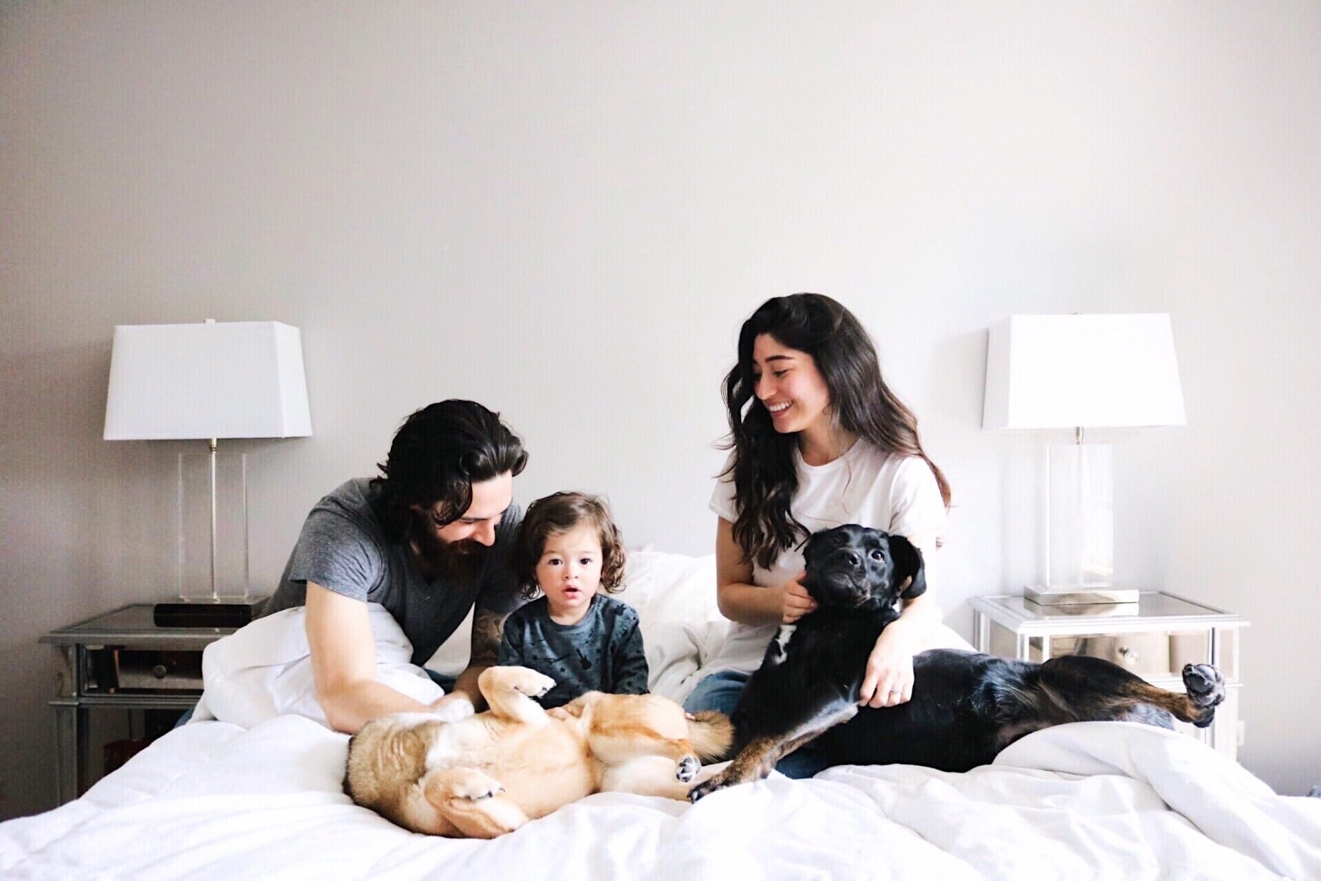 family sitting on a bed