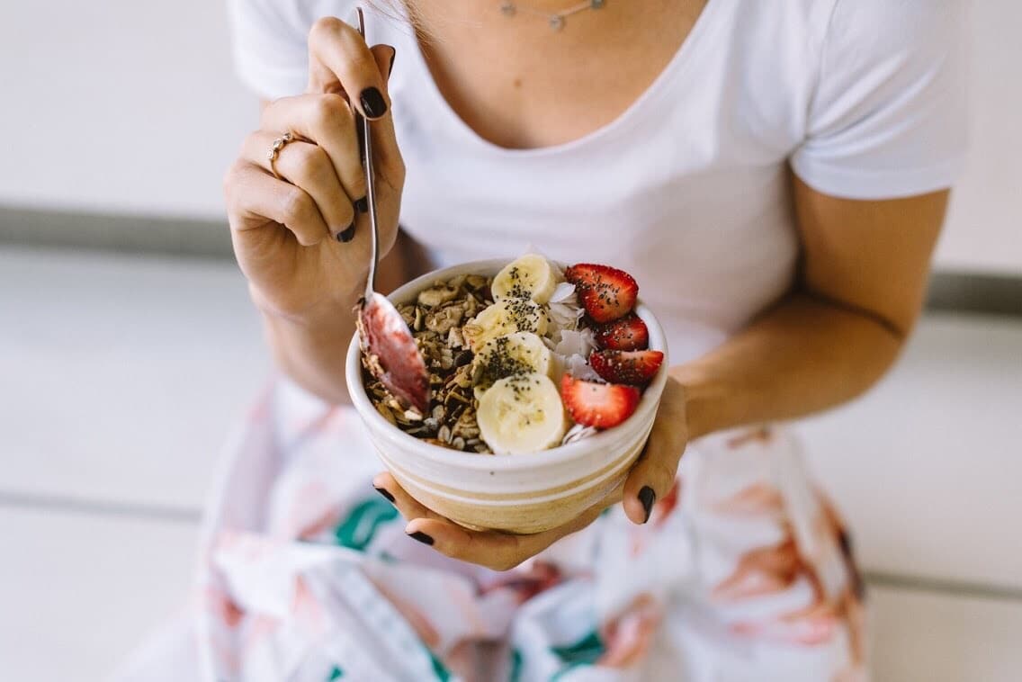 woman eating an acai bowl