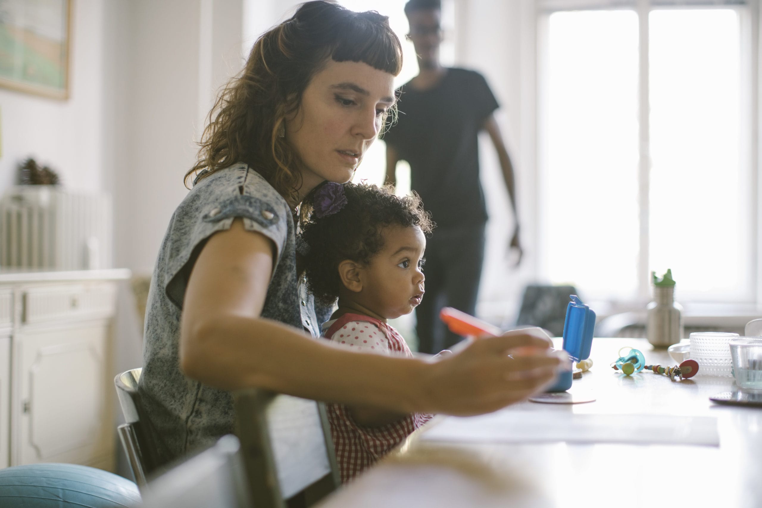 mom working with a child on her lap