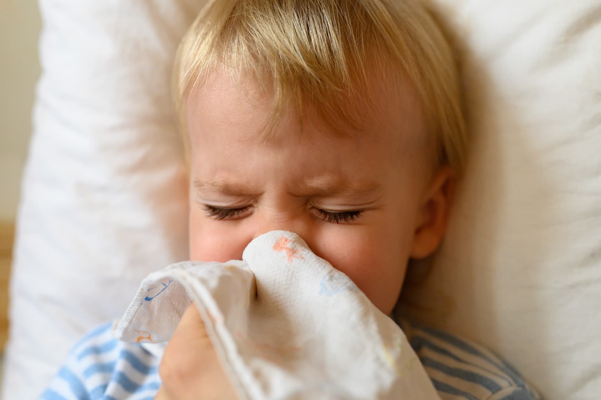 child blowing his nose