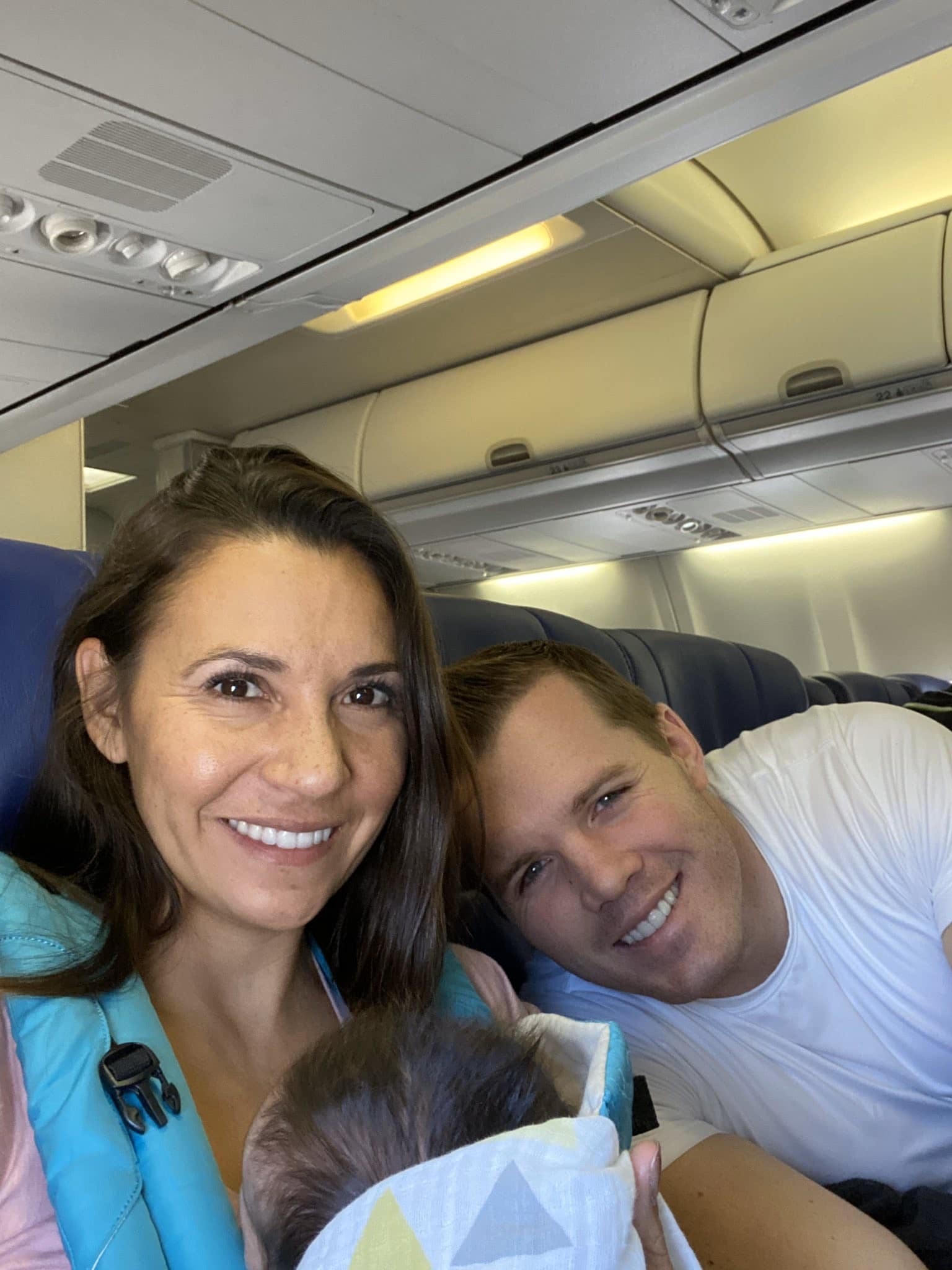 couple on a plane with a newborn baby