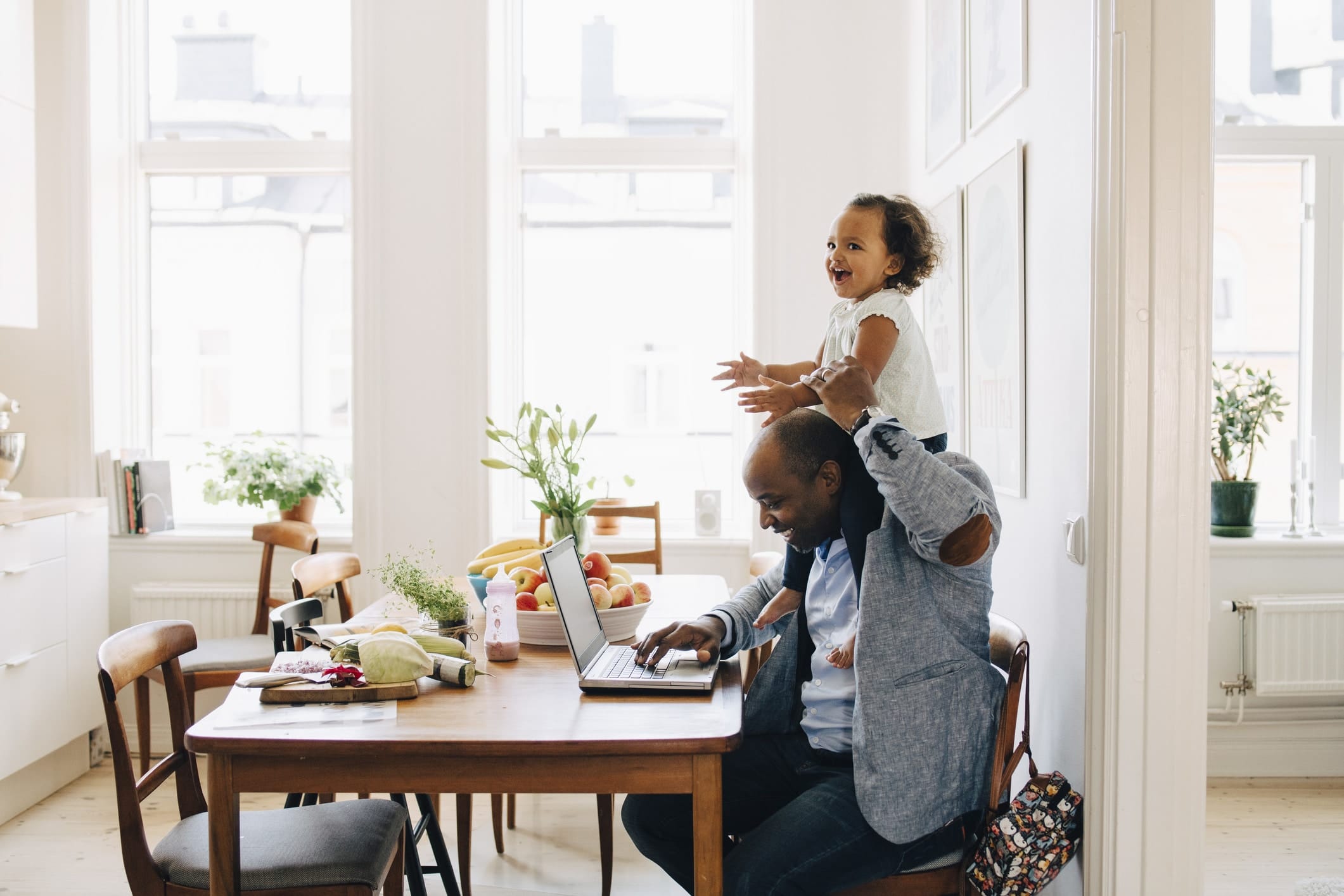 dad working with a toddler on his shoulders