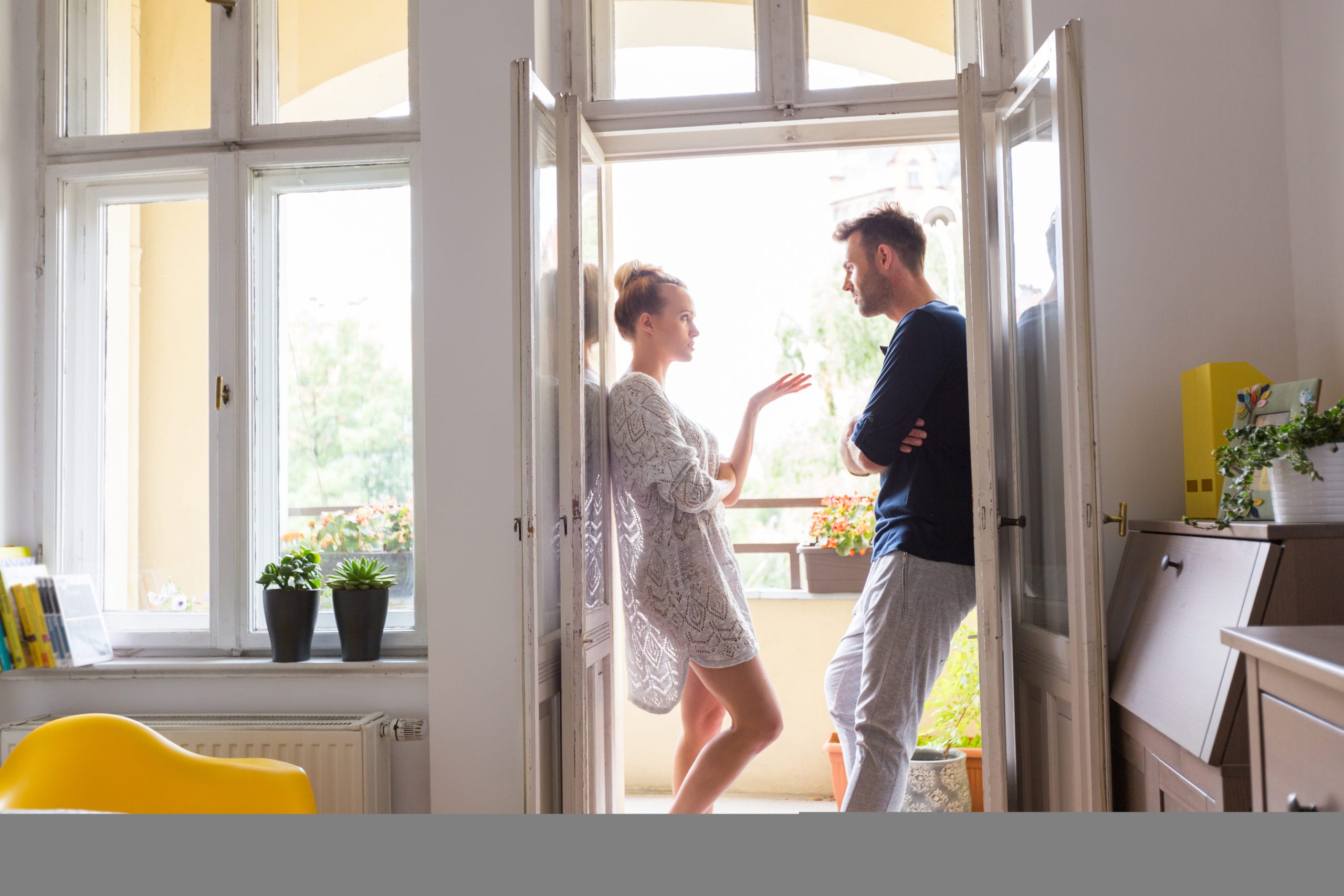 couple standing in a doorway talking