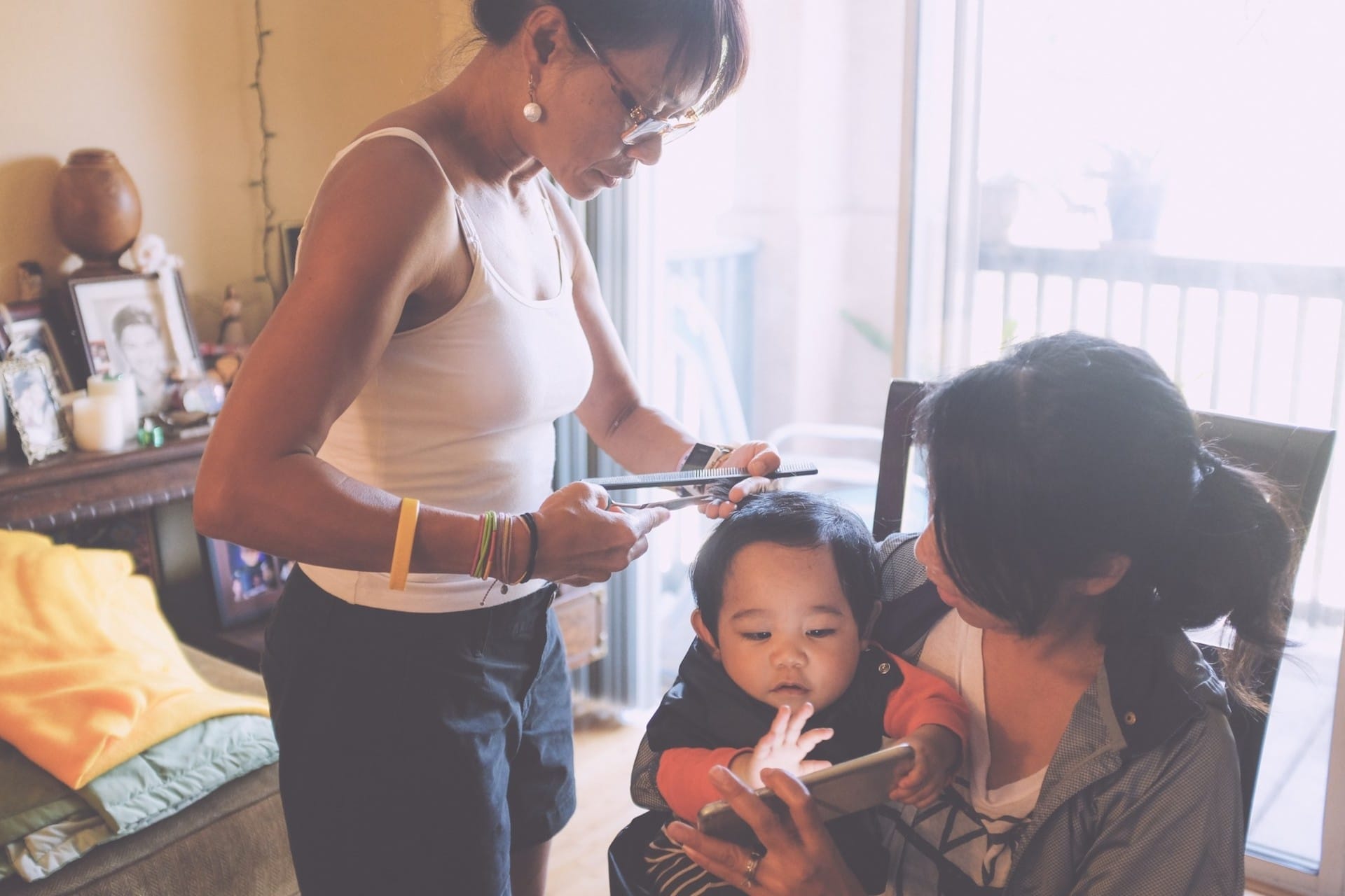 mom cutting little girls hair