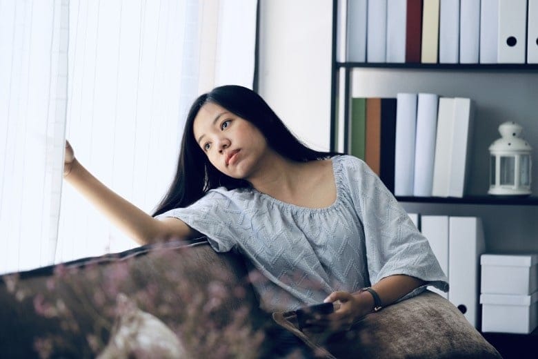 woman looking out a window