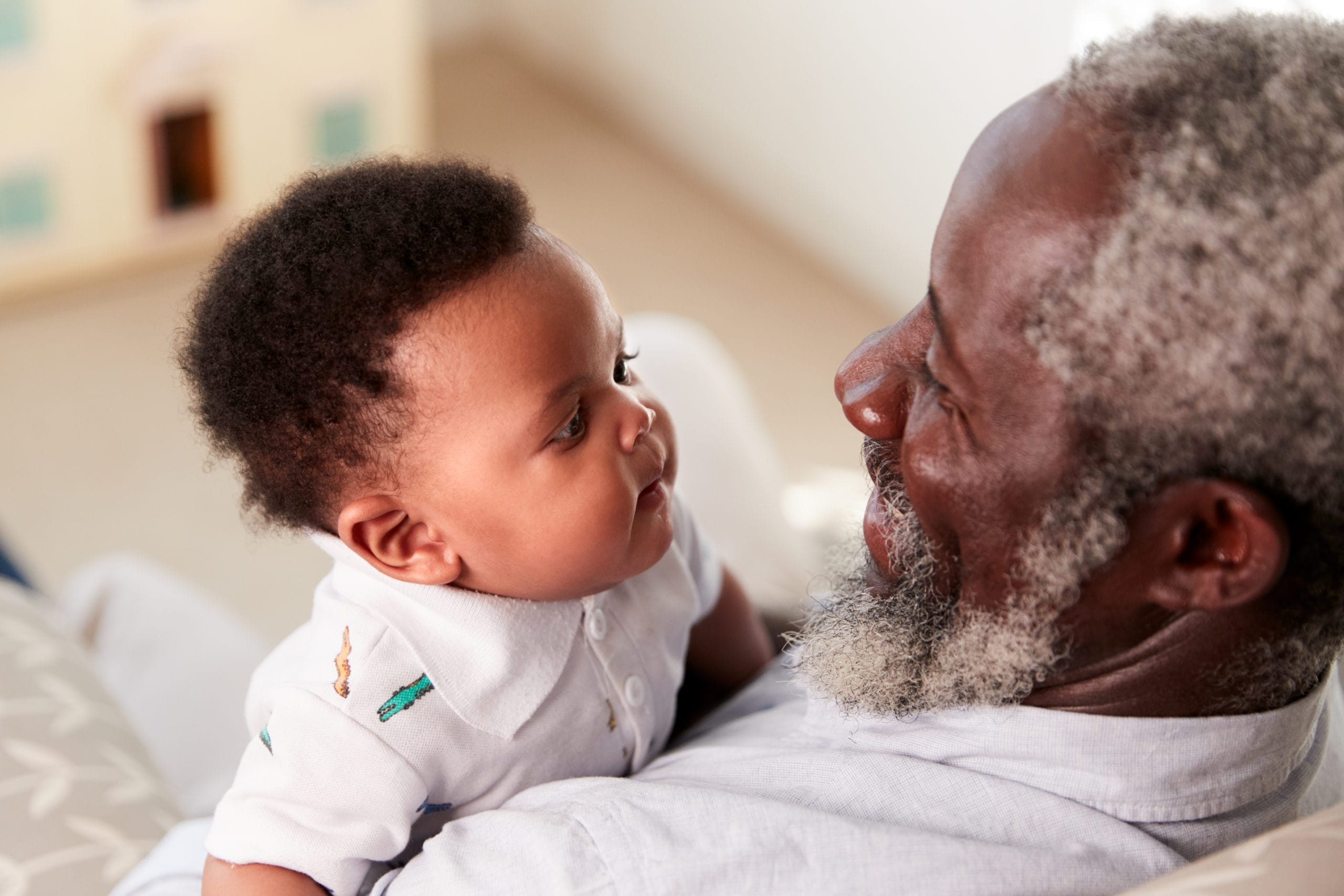 grandpa holding newborn baby