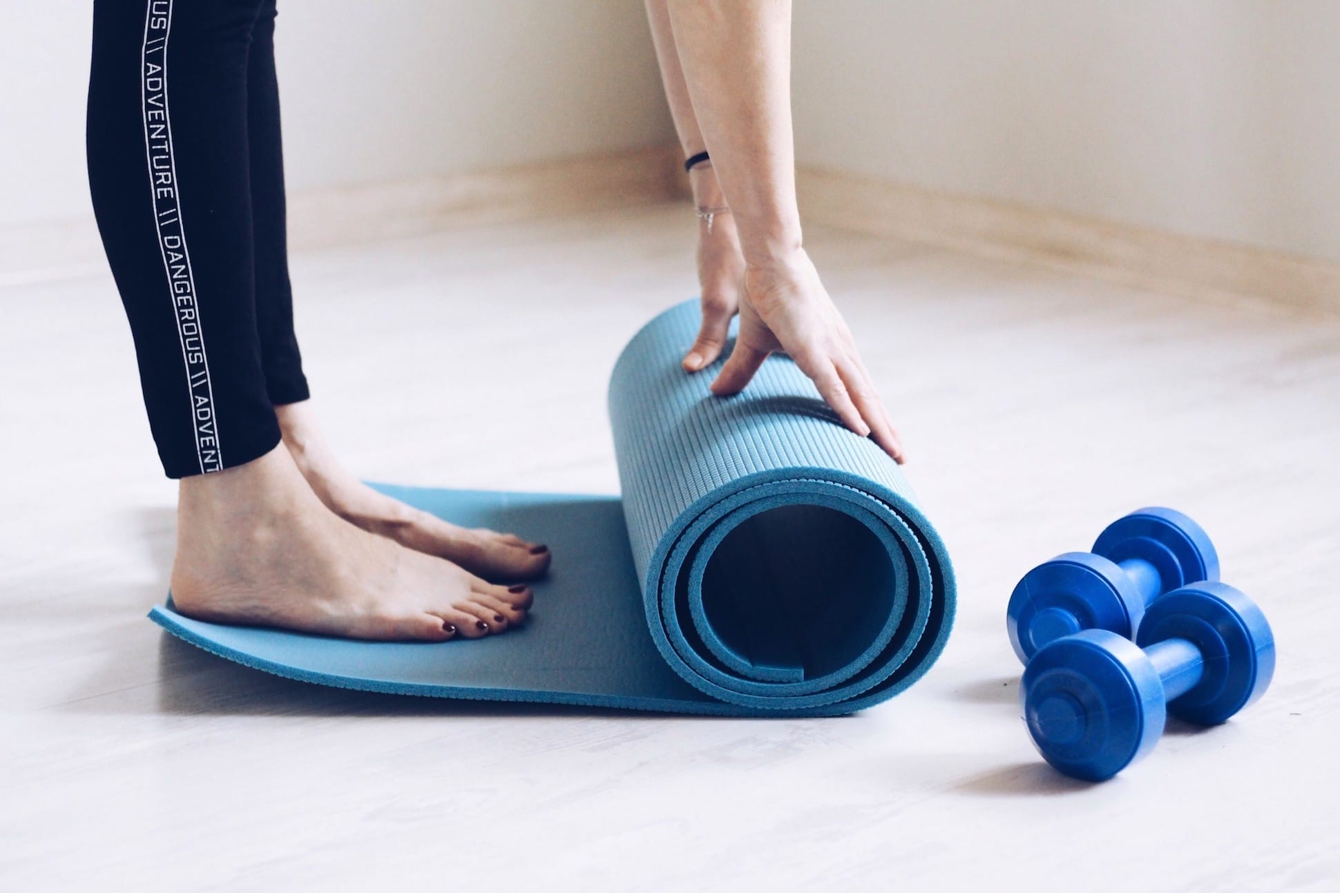 woman unrolling yoga mat