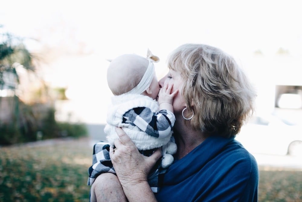 grandma kissing baby on the cheek