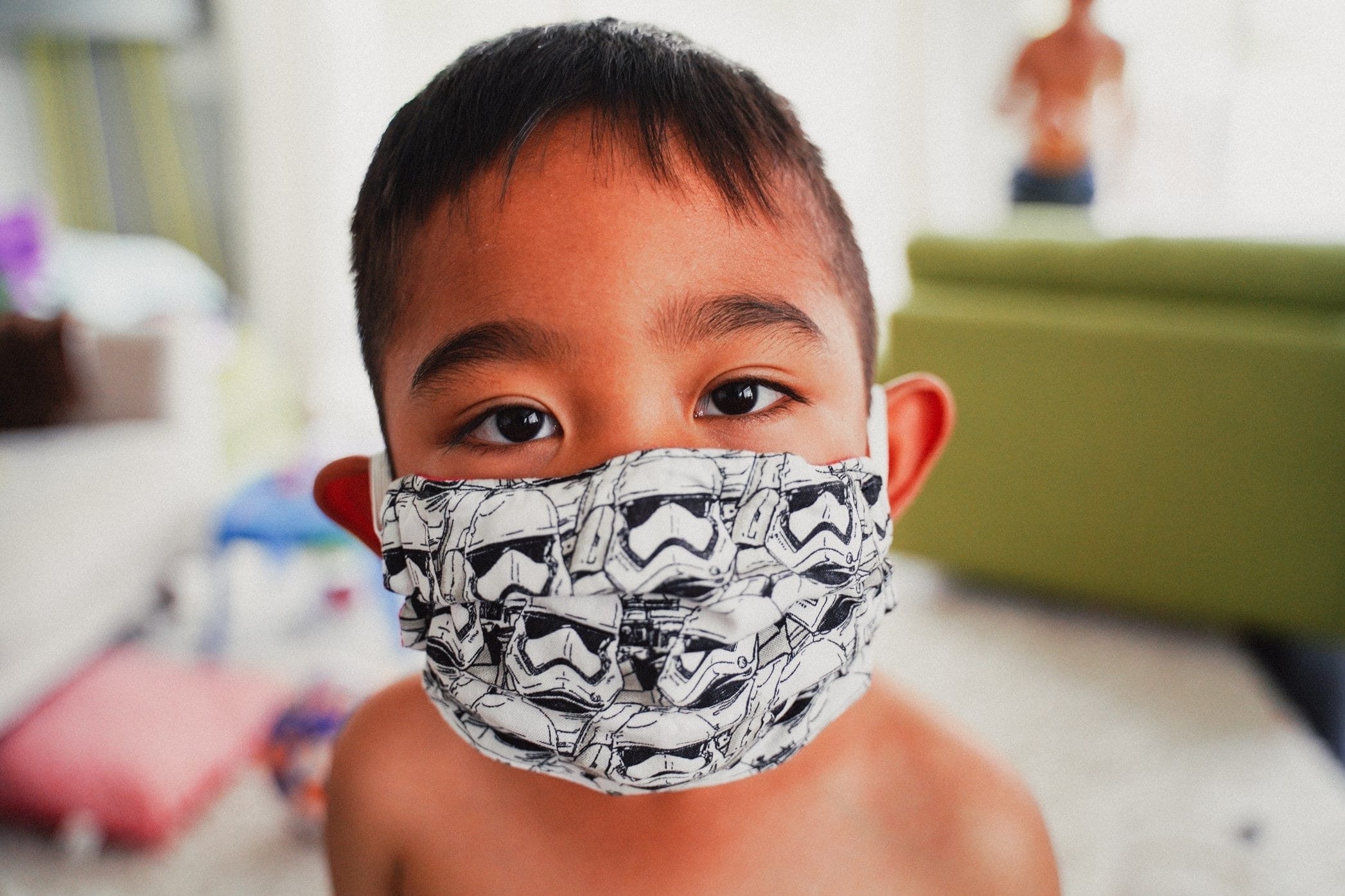 little boy wearing a mask