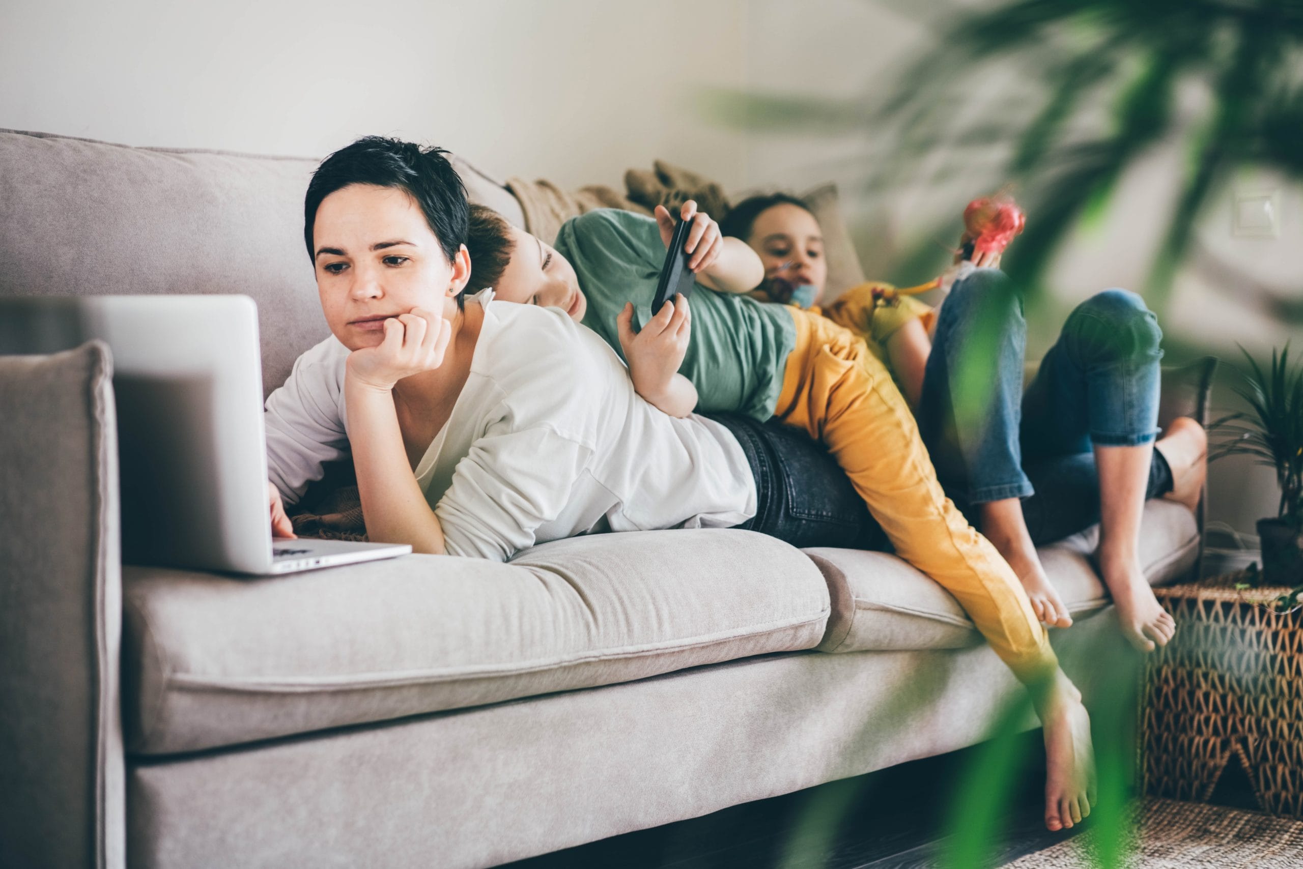 mom working with child climbing on top of her