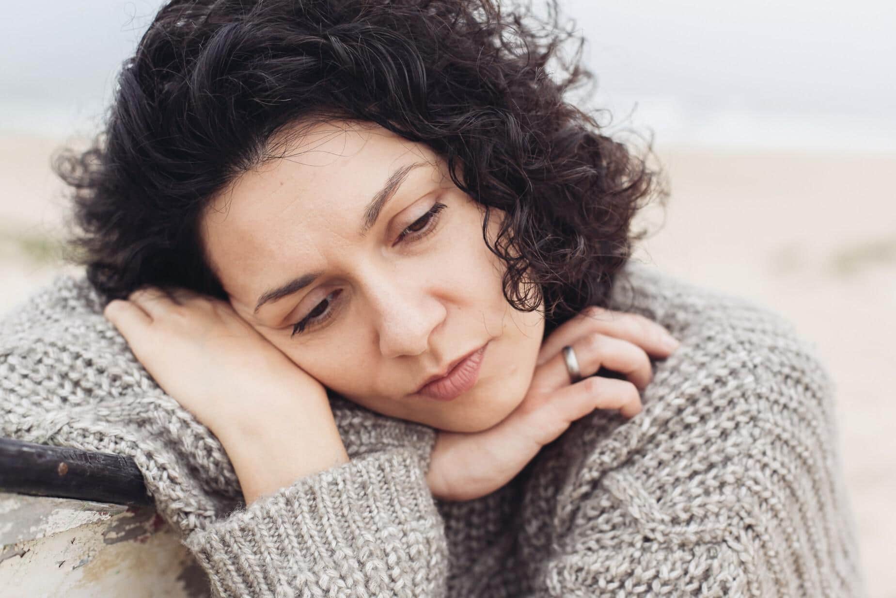 upset woman with her head on her hands